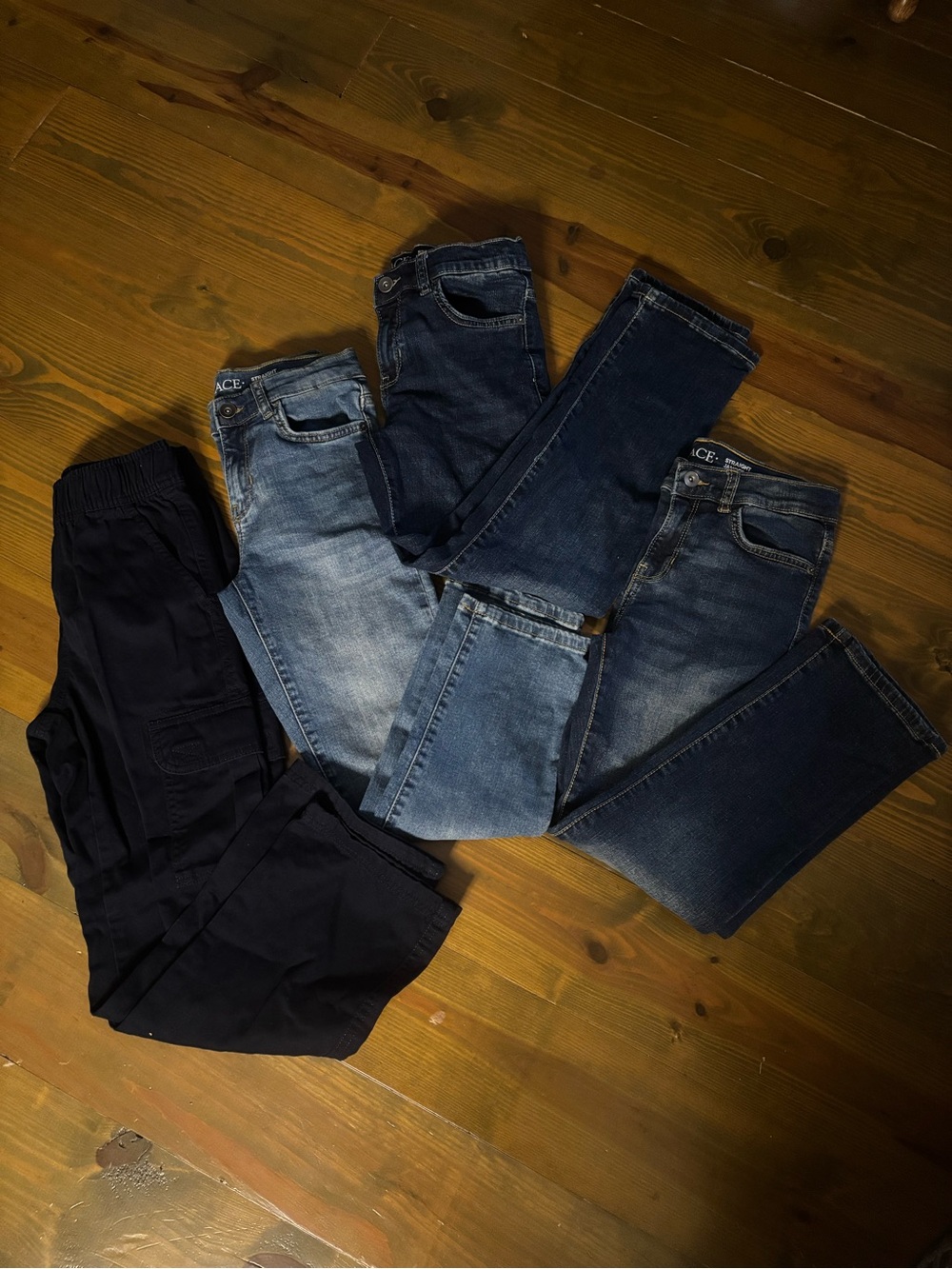 Three pairs of The Childrens place jeans and 1 pair of TCP navy cargo pants